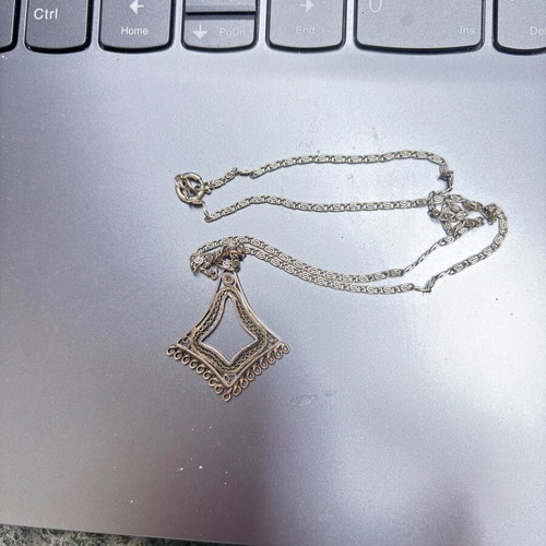Silver vintage pendant with intricate chain