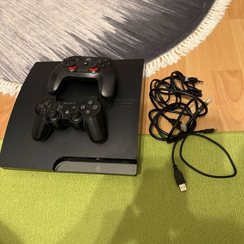 Sony PlayStation 3 Slim 320GB console used with 2 controllers and cables