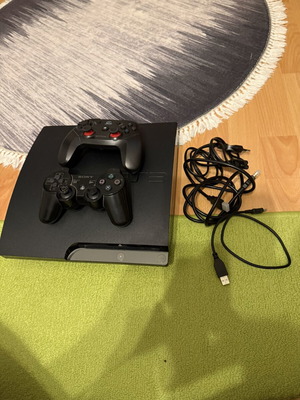 Sony PlayStation 3 Slim 320GB console used with 2 controllers and cables