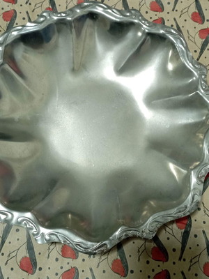 Vintage stainless steel fondue pot used with signs of wear