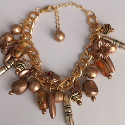 Gold bracelet with various charms handmade from scratch
