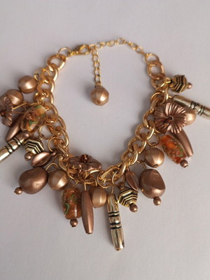 Gold bracelet with various charms handmade from scratch
