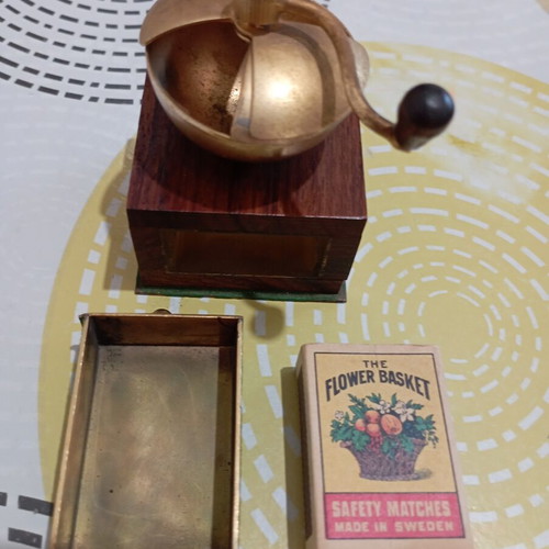 Vintage miniature manual coffee grinder with wooden body and brass hopper