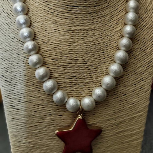 Necklace with matte white phosphorescent beads and red star pendant