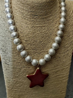 Necklace with matte white phosphorescent beads and red star pendant