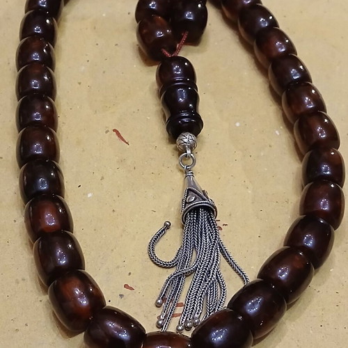 Amber worry beads used with silver elements and tassel