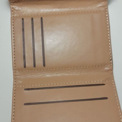 Black wallet new with gold emblem and beige lining