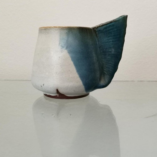Clay handmade mug used with wavy handle