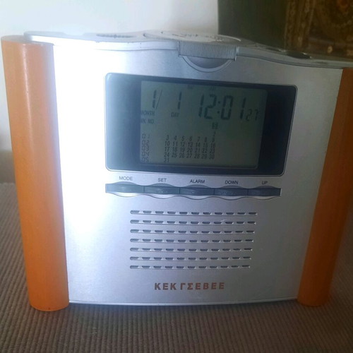 Retro digital tabletop clock with day, month, and year display
