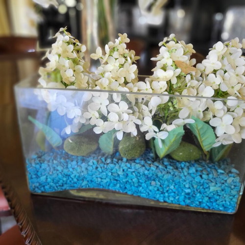 Modern arrangement with artificial hydrangeas in glass vase