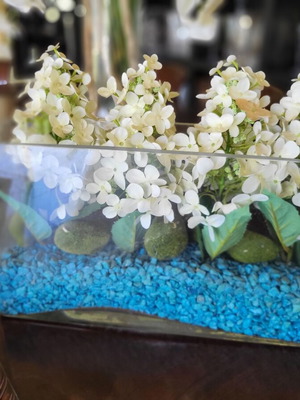 Modern arrangement with artificial hydrangeas in glass vase