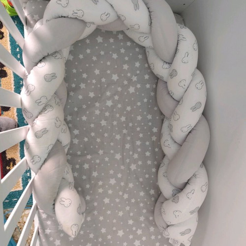 Baby braided crib bumper used in gray and white