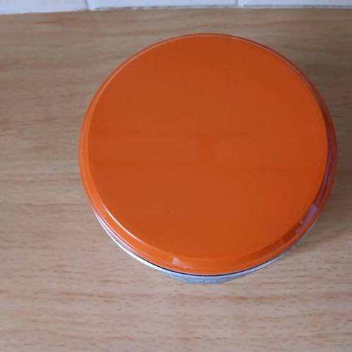 Metal biscuit tin like new with orange lid and designs