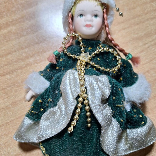 Porcelain doll on stand like new