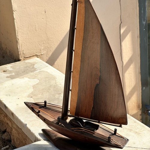 Handmade wooden sailboat used on base, modern nautical decoration