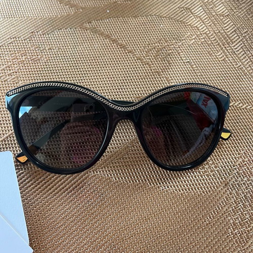 Nina Ricci SNR097 sunglasses like new, black oval acetate frame with chain design
