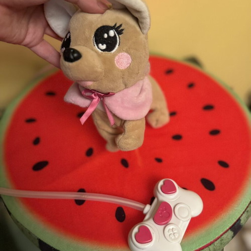 Plush dog with pink wired controller