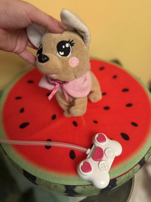 Plush dog with pink wired controller