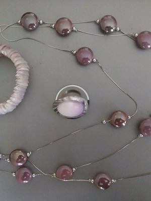 Jewelry set used in lilac shades with necklace, ring, and shell bracelet