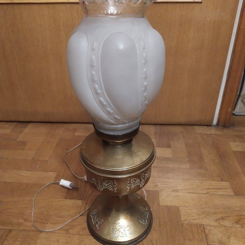 Vintage table lamp in old oil lamp style with glass, used