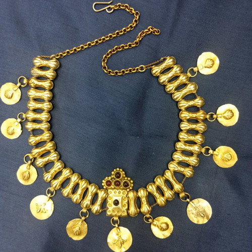 Traditional necklace with vintage symbols used, yellow light color, copper