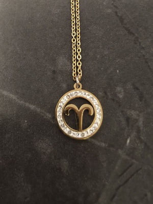 Necklace made of stainless steel, like new, gold color with Aries zodiac and rhinestones