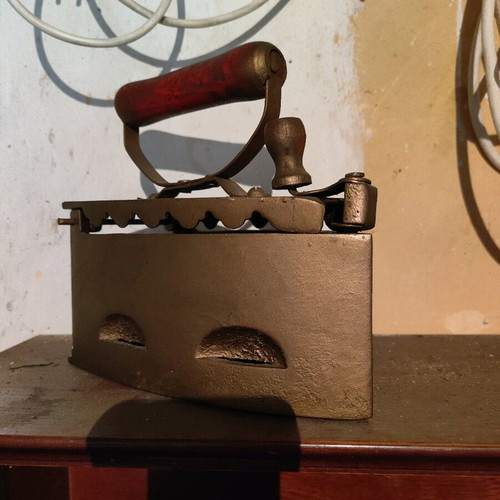Antique charcoal iron used, gold tone