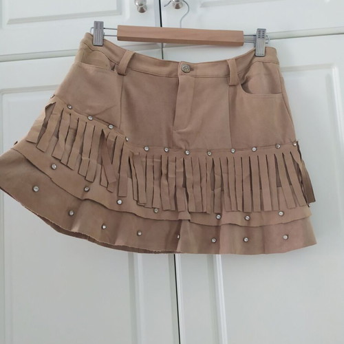 Skirt used with suede-type fringes and matte antique gold details