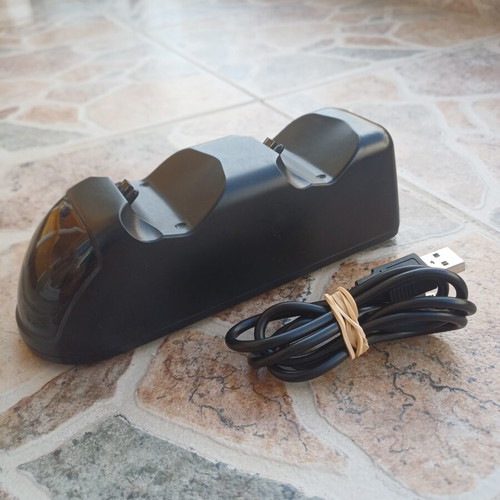 PlayStation 4 Slim 1TB console with red DualShock 4 and charging dock