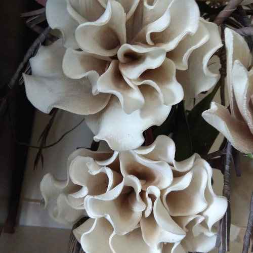 Decorative floral arrangement with large earth-tone flowers