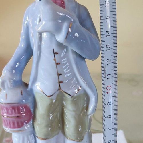 Vintage porcelain figurine Victorian man with bird and cage