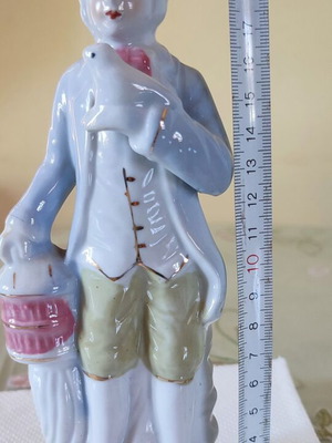 Vintage porcelain figurine Victorian man with bird and cage
