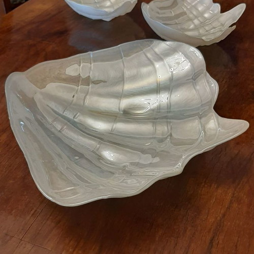 Three platters in the shape of a conch