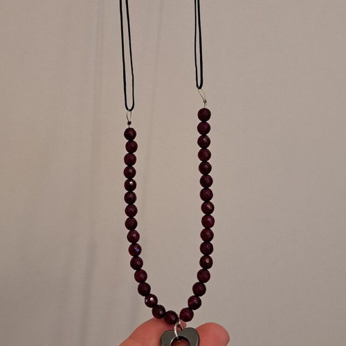 Necklace with black cord, burgundy polygonal beads and hematite key pendant like new