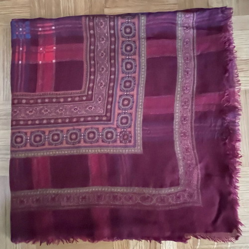 Burgundy scarf with decorative border and fringe used