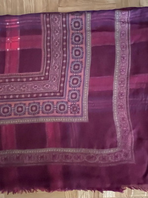 Burgundy scarf with decorative border and fringe used