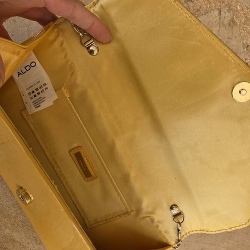 Aldo yellow vinyl clutch bag used with gold trim