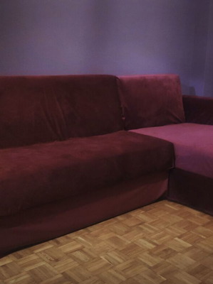 Corner sofa bed used with storage and removable burgundy cover