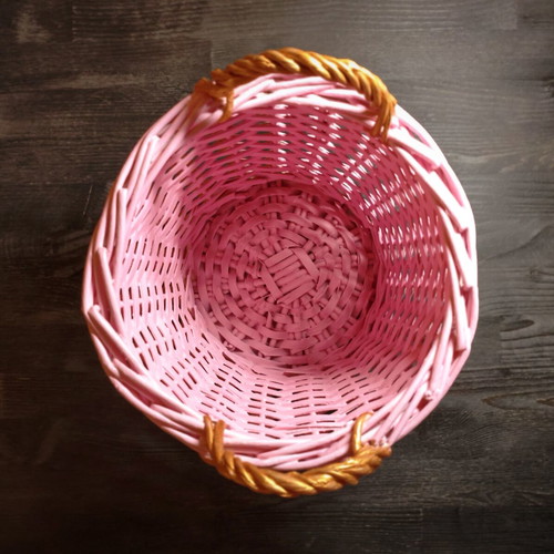 Decorative pink rattan basket with gold handles, handmade