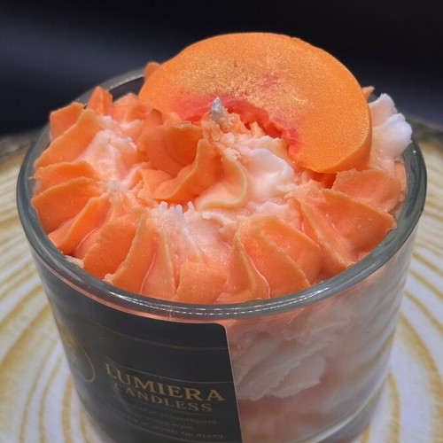 Handmade soy candle in glass container with peach scent
