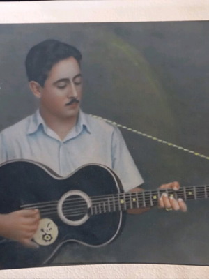 Photograph of man playing laiki guitar used