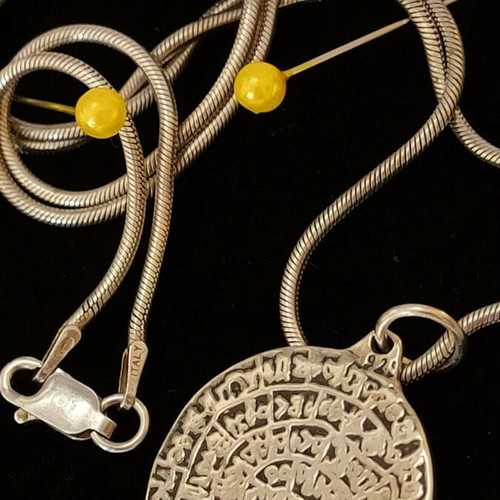 Necklace with 9.25 silver chain and Phaistos disc like new