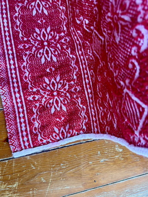 Vintage red wool blanket with geometric and floral patterns
