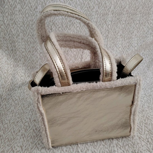 Handbag gold like new with fur details and long strap