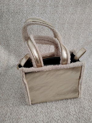 Handbag gold like new with fur details and long strap