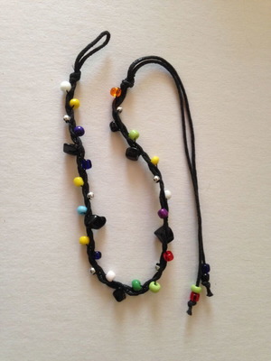 Bracelet used with multicolored beads and black cord