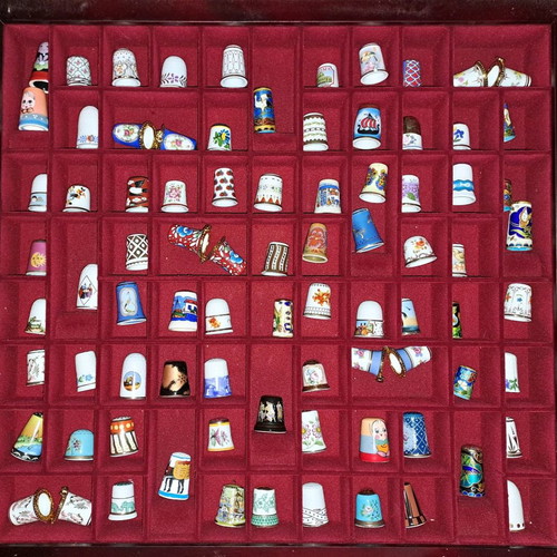 Porcelain thimble collection with wooden display case and book