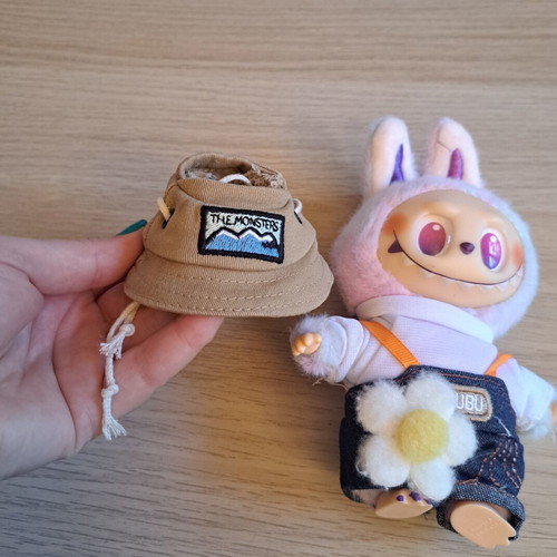 Labubu doll with pastel pink, purple, and blue clothes like new