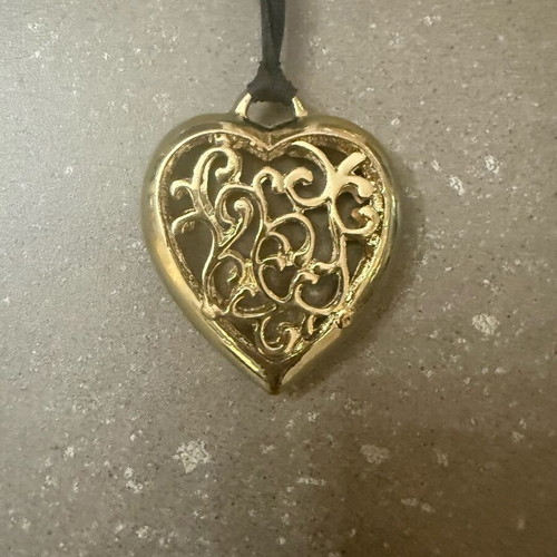 Long heart necklace with black cord like new, gold color
