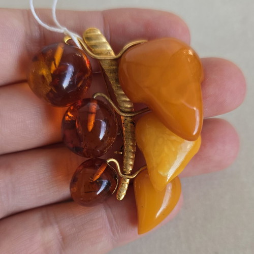 Baltic amber brooch with grape cluster design